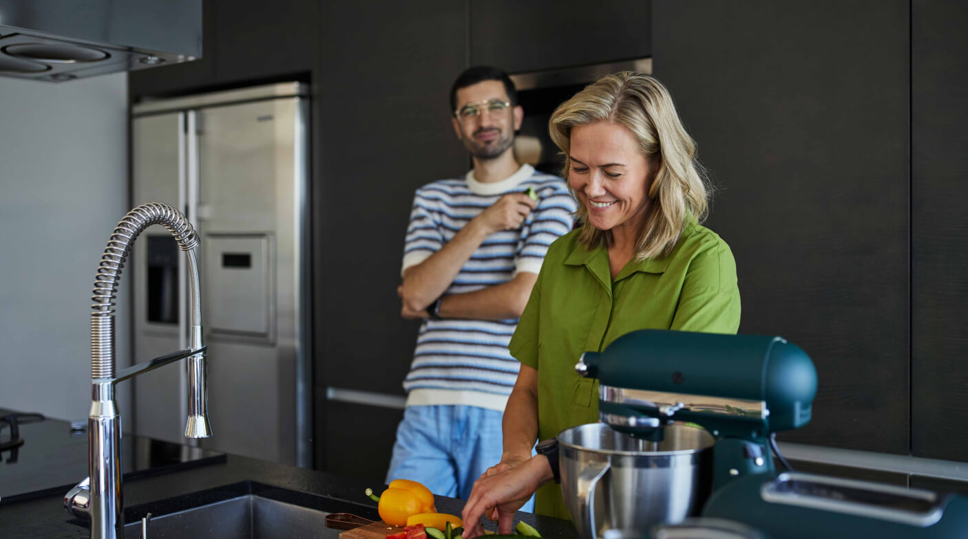 Two people preparing food in a modern well-equipped kitchen